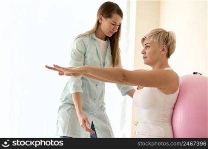 female patient undergoing therapy with physiotherapist 2