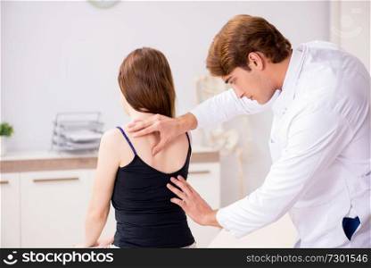 Female patient visiting young handsome doctor chiropractor 