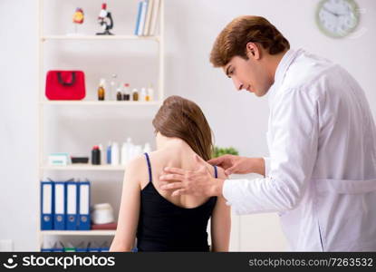 Female patient visiting young handsome doctor chiropractor . The female patient visiting young handsome doctor chiropractor 