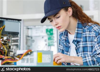 female pc technician fixing a pc