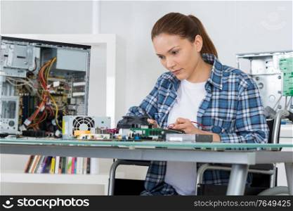 female pc technician fixing computer
