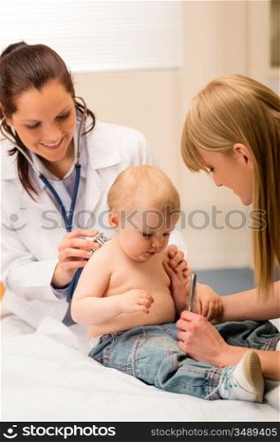 Female pediatrician checking cute baby girl with stethoscope