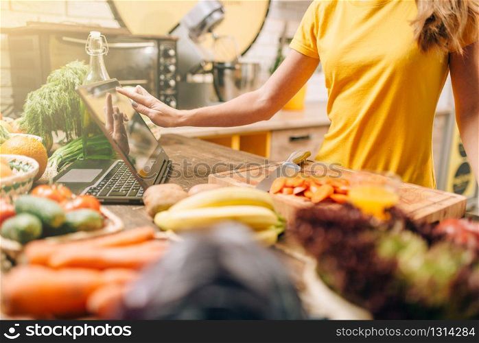 Female person cooking on the kitchen, healthy food. Vegetarian diet, fresh vegetables and fruits