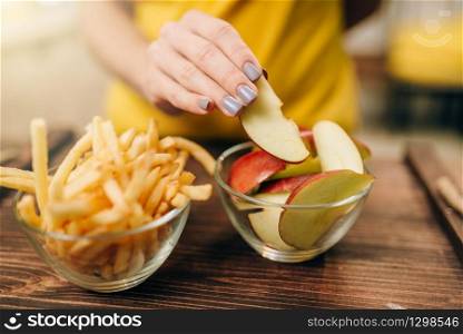Female person hand with apple piece, healthy bio food. Vegetarian diet concept