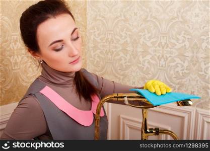 Female person hands in rubber gloves cleans bathroom. Housekeeping concept. Female hands in rubber gloves cleans bathroom