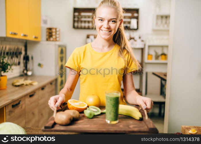 Female person holding a tray with cocktail, fruits and vegetables, cooking organic food. Vegetarian diet, healthy lifestyle concept. Female person with cocktail, fruits and vegetables