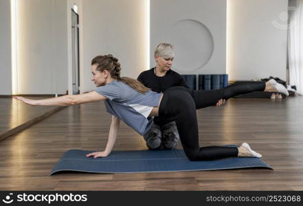female personal trainer helping her client long view