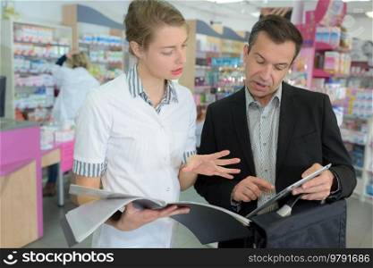 female pharmacist talking to a commercial