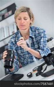 female photographer cleaning lens