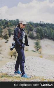 Female photographer strolling through the mountains