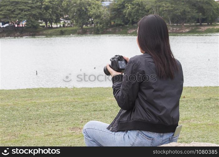 Female photographer takes photo , Behind