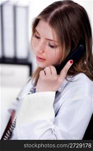 female physician talking over phone in the hospital