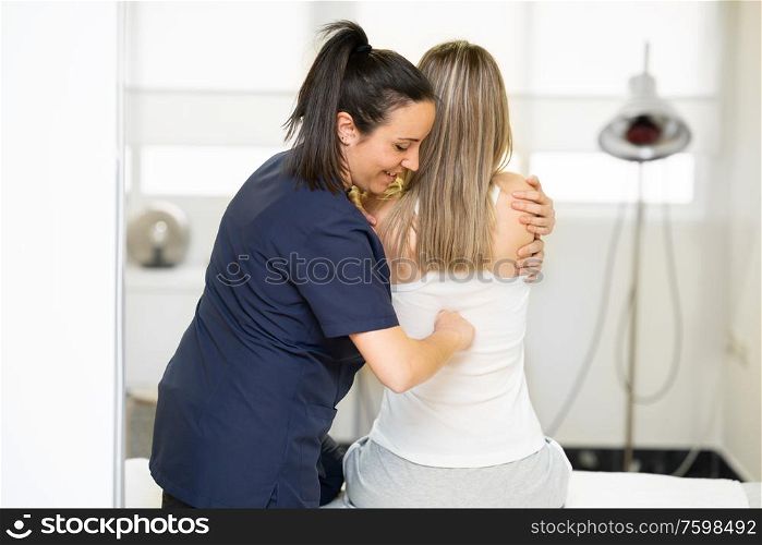 Female Physiotherapist inspecting her patient. Medical check in a physiotherapy center.. Physiotherapist inspecting her patient in a physiotherapy center.