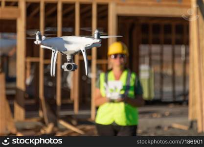 Female Pilot Flies Drone Quadcopter Inspecting Construction Site.