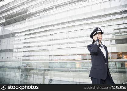 Female pilot talking on a mobile phone