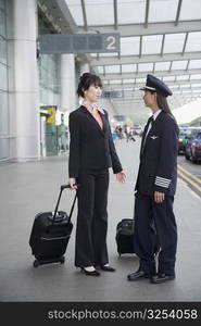 Female pilot talking to a female cabin crew