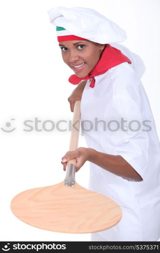 female pizza cook using a spade