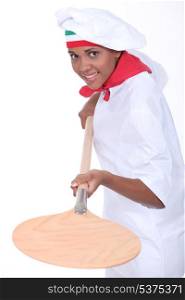 female pizza cook using a spade
