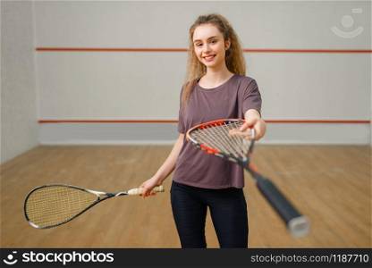 Female player gives squash racket. Girl on game training, active sport hobby on court, fit workout for healthy lifestyle. Female player gives squash racket