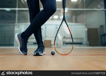 Female player legs, squash racket and ball. Girl on game training, active sport hobby on court, fitness workout for healthy lifestyle. Female player legs, squash racket and ball