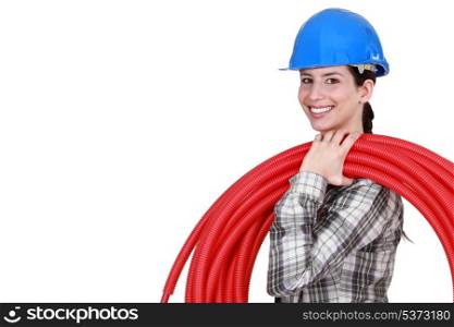 female plumber carrying hose