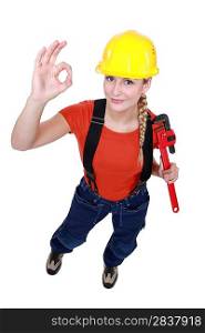 Female plumber giving the OK