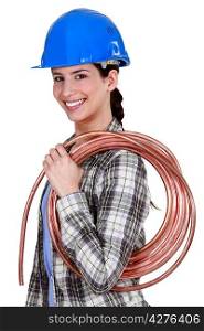 Female plumber holding pipe