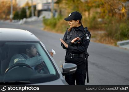 Female police officer refuse to take bribe from male car driver. Fight against road corruption. Female police officer refuse bribe from driver