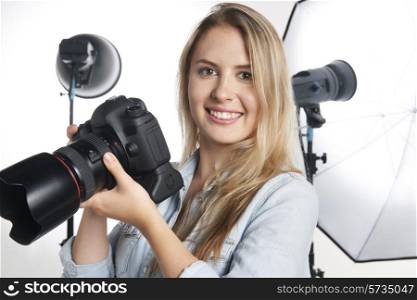Female Professional Photographer Working In Studio