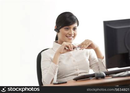 Female professional smiling while looking at computer