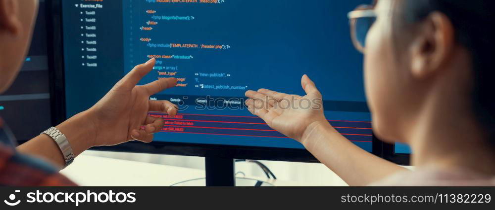 Female programer explain while pointing code displayed on computer. Professional programmer present data analysis and writing java script at modern company office. Closeup. Burgeoning.. Female programer explain while pointing code displayed on computer. Burgeoning.