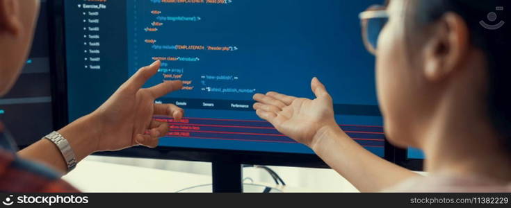 Female programer explain while pointing code displayed on computer. Professional programmer present data analysis and writing java script at modern company office. Closeup. Burgeoning.. Female programer explain while pointing code displayed on computer. Burgeoning.
