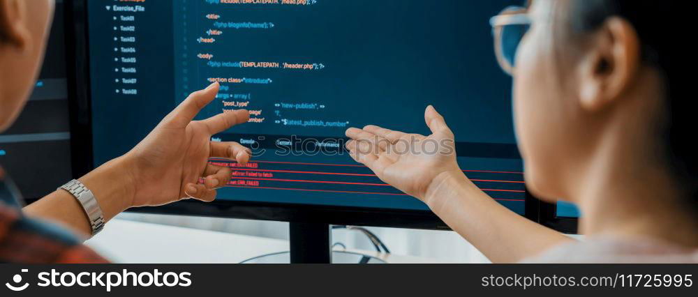 Female programer explain while pointing code displayed on computer. Professional programmer present data analysis and writing java script at modern company office. Closeup. Burgeoning.. Female programer explain while pointing code displayed on computer. Burgeoning.