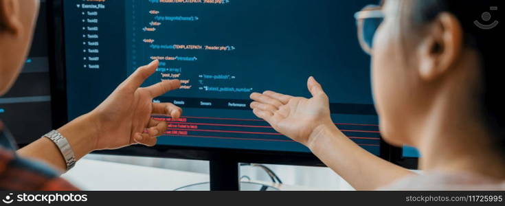 Female programer explain while pointing code displayed on computer. Professional programmer present data analysis and writing java script at modern company office. Closeup. Burgeoning.. Female programer explain while pointing code displayed on computer. Burgeoning.