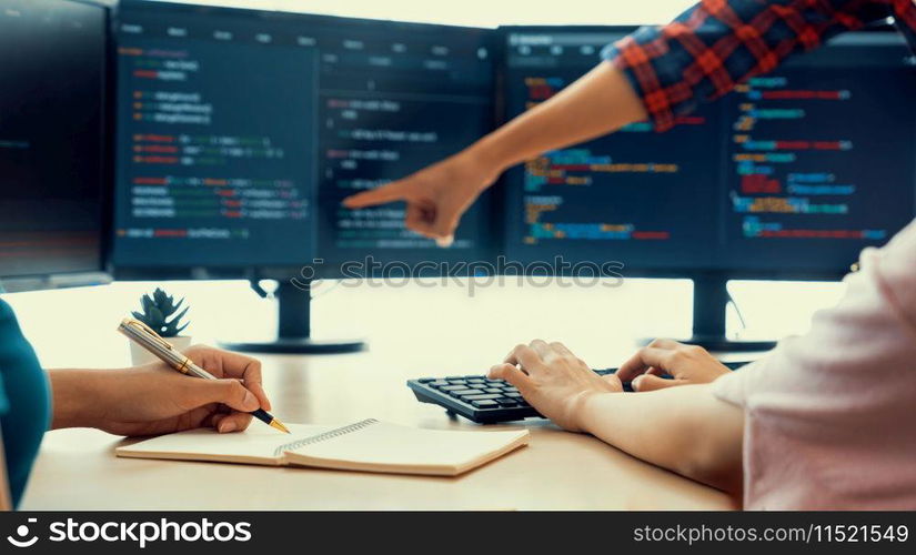 Female programer taking a note while young skilled web developer present program while computer displayed program code at modern office company. Java script, web design concept. Burgeoning.. Female programer taking a note while web developer present program. Burgeoning.