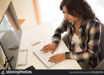 Female programmer working on desktop computer