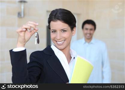 Female promoter showing keys of a house