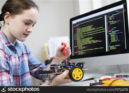 Female Pupil Building Robot Car In School Science Lesson