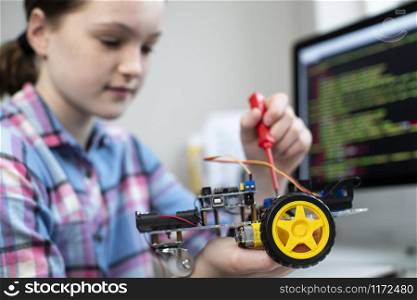 Female Pupil Building Robot Car In School Science Lesson