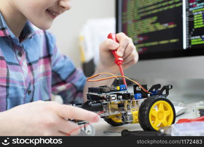 Female Pupil Building Robot Car In School Science Lesson