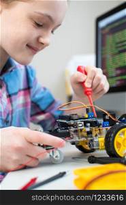 Female Pupil Building Robotic Car In Science Lesson