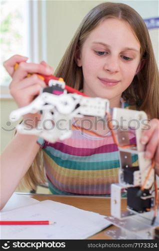 Female Pupil In Science Lesson Studying Robotics