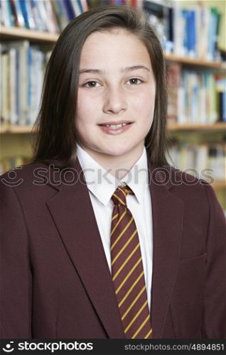 Female Pupil Wearing School Uniform Standing In Library
