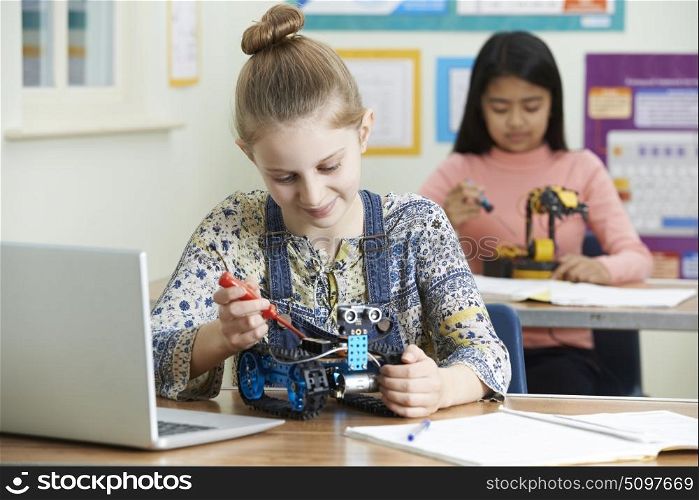 Female Pupils In Science Lesson Studying Robotics