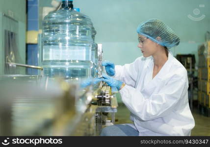 Female quality control workers in a drinking water factory Inspecting the quality of water tanks before importing the drinking water belt into the tank