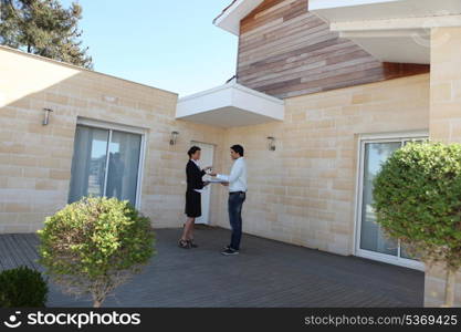 female real estate agent and young man buying house