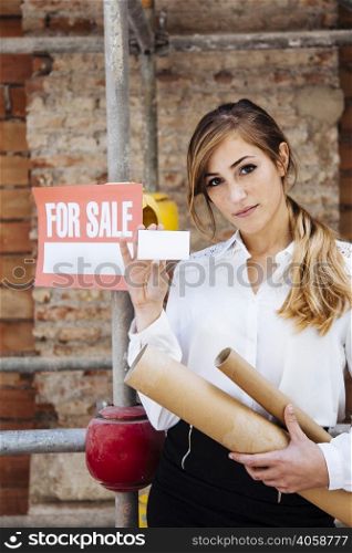 female real estate agent showing business card