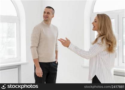 female realtor showing man new house