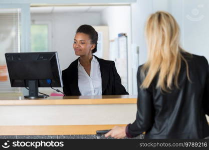 female receptionist attending beautiful passenger