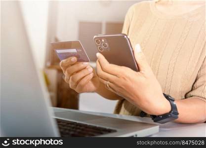 Female register via credit cards on mobile phone make digital payment security online, Business woman hands holding credit card and smartphone to pay product at home, Internet online shopping concept